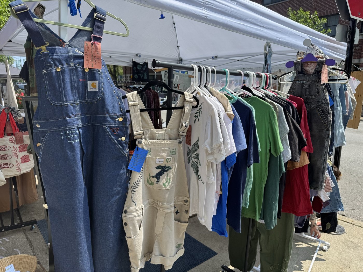 A rack of one-of-one Found Slowly garments at market