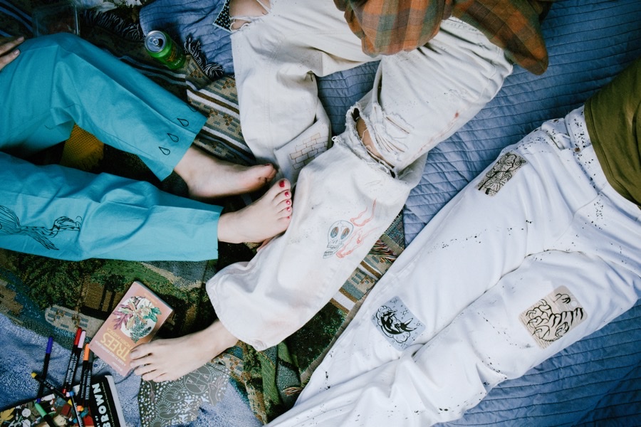 Printed garments spread across a blanket